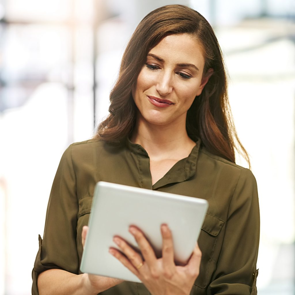 Cropped shot of a young businesswoman using a digital tablet in an office