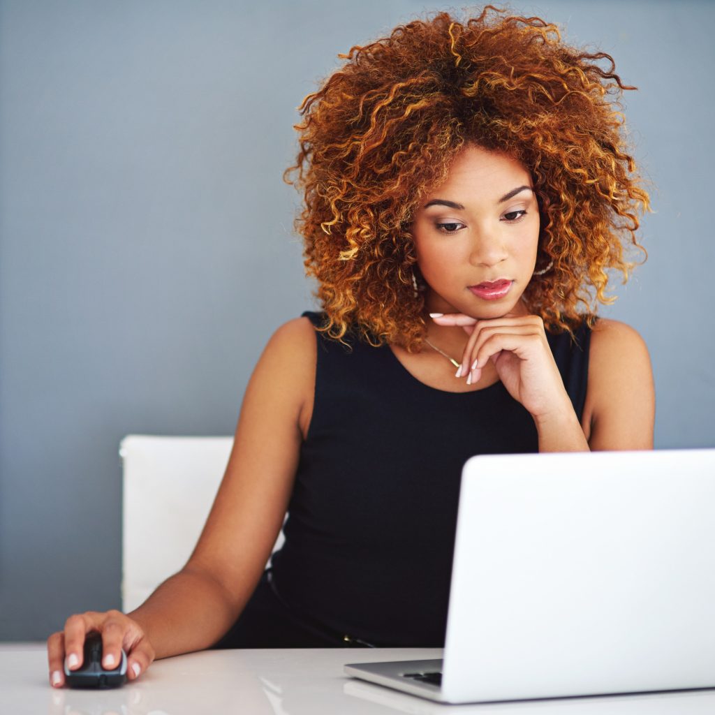 Shot of a young businesswoman working on a laptop at her desk